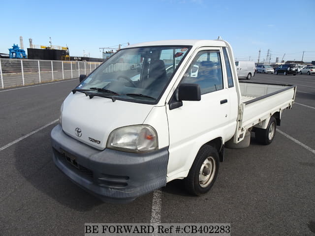 A grey JDM sports car speeding down a highway at night.