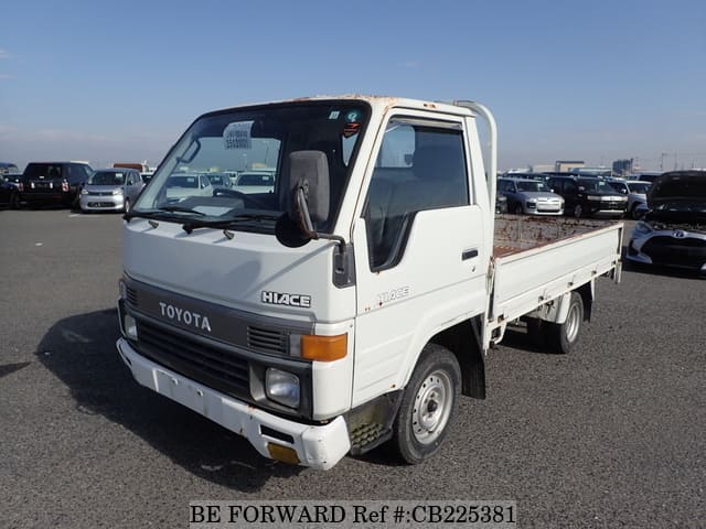 A grey JDM sports car speeding down a highway at night.