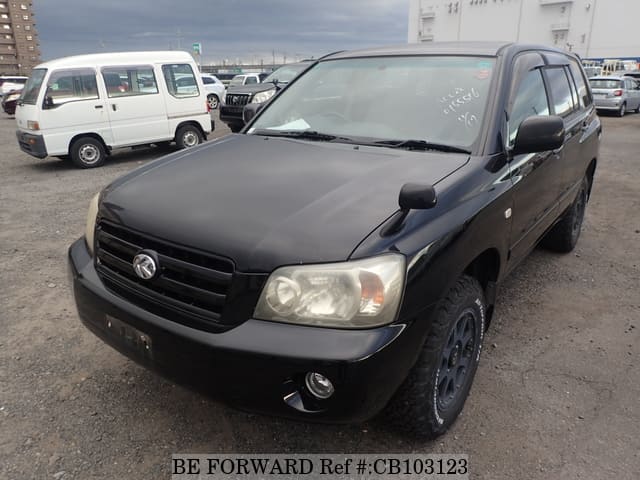 A grey JDM sports car speeding down a highway at night.