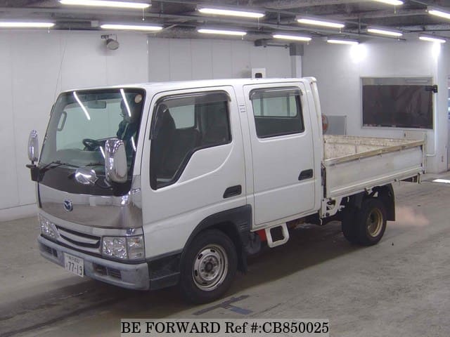 A grey JDM sports car speeding down a highway at night.