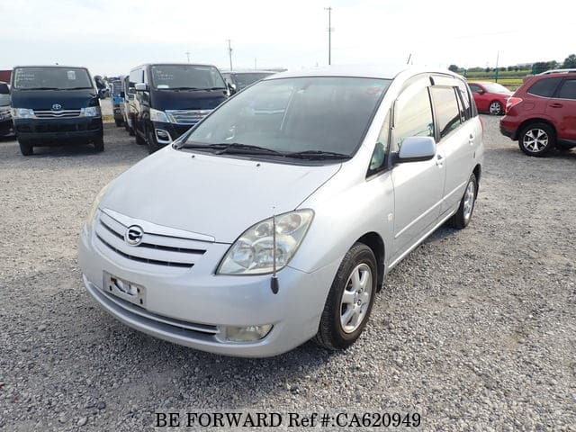 A grey JDM sports car speeding down a highway at night.