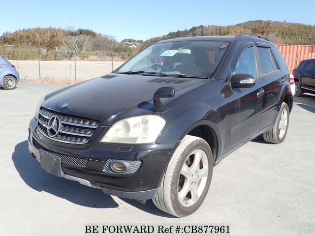 A grey JDM sports car speeding down a highway at night.