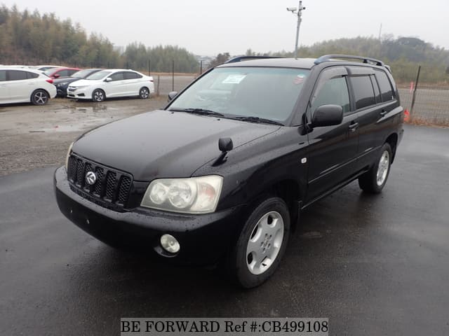 A grey JDM sports car speeding down a highway at night.