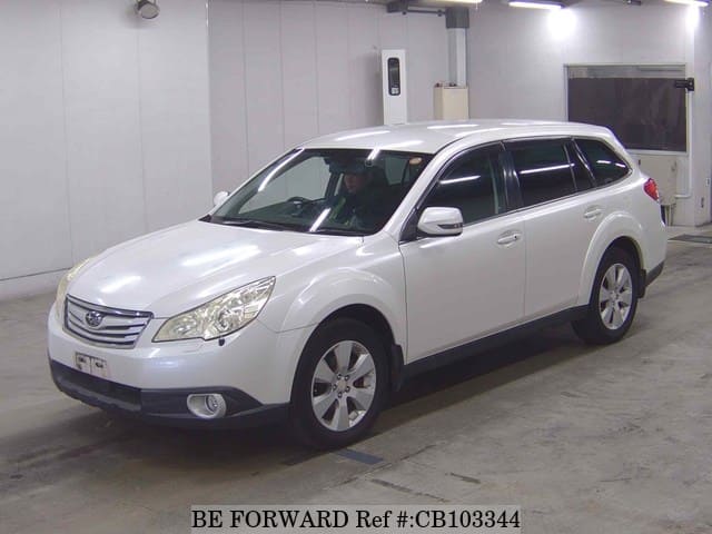 A grey JDM sports car speeding down a highway at night.