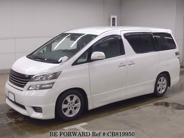 A grey JDM sports car speeding down a highway at night.