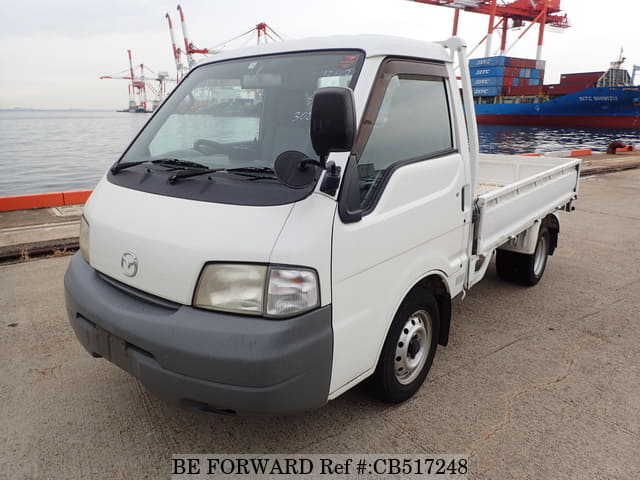 A grey JDM sports car speeding down a highway at night.