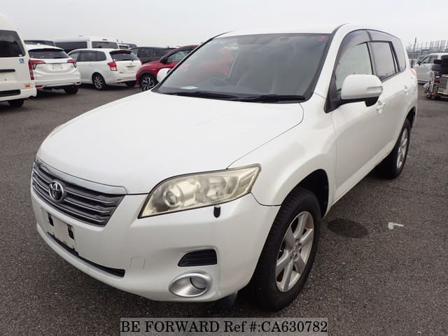 A grey JDM sports car speeding down a highway at night.