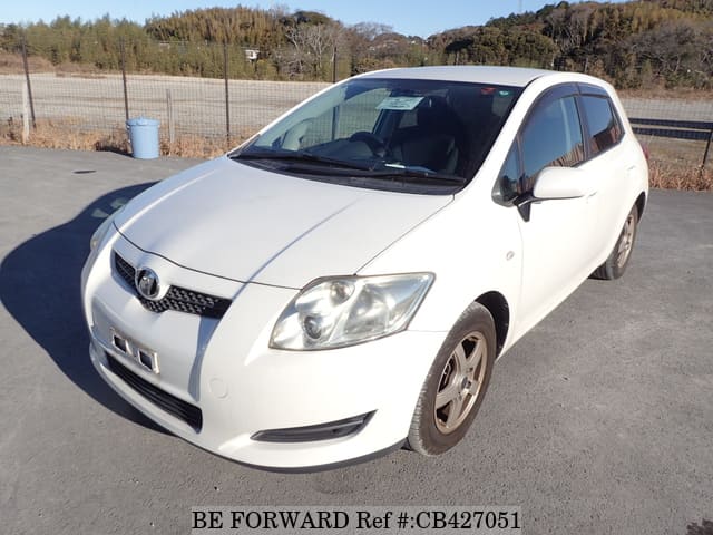 A grey JDM sports car speeding down a highway at night.