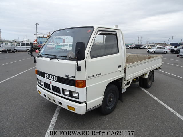 A grey JDM sports car speeding down a highway at night.