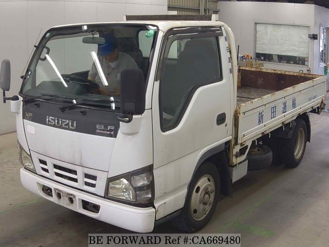 A grey JDM sports car speeding down a highway at night.