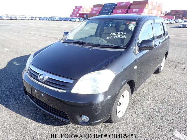 A grey JDM sports car speeding down a highway at night.