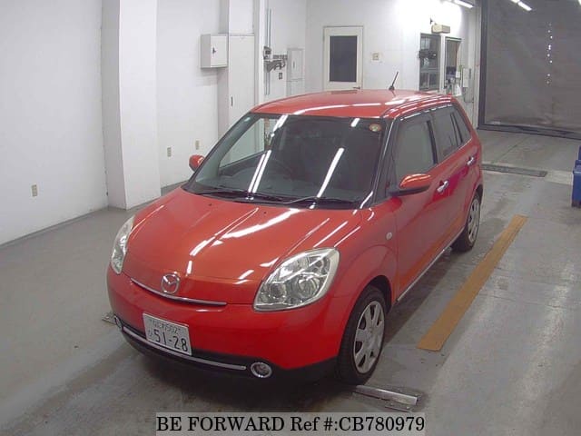 A grey JDM sports car speeding down a highway at night.