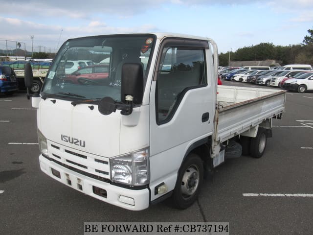 A grey JDM sports car speeding down a highway at night.