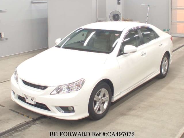 A grey JDM sports car speeding down a highway at night.