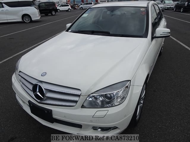 A grey JDM sports car speeding down a highway at night.