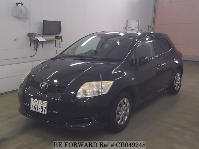 A grey JDM sports car speeding down a highway at night.