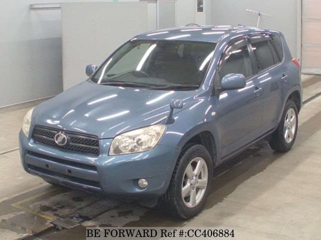 A grey JDM sports car speeding down a highway at night.