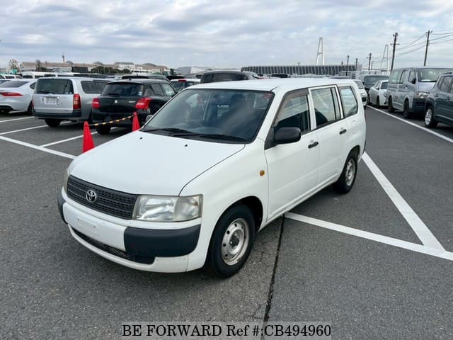 A grey JDM sports car speeding down a highway at night.