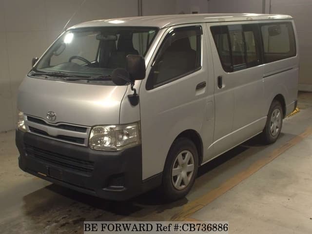 A grey JDM sports car speeding down a highway at night.