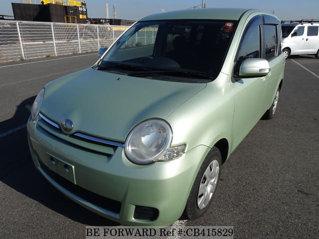 A grey JDM sports car speeding down a highway at night.