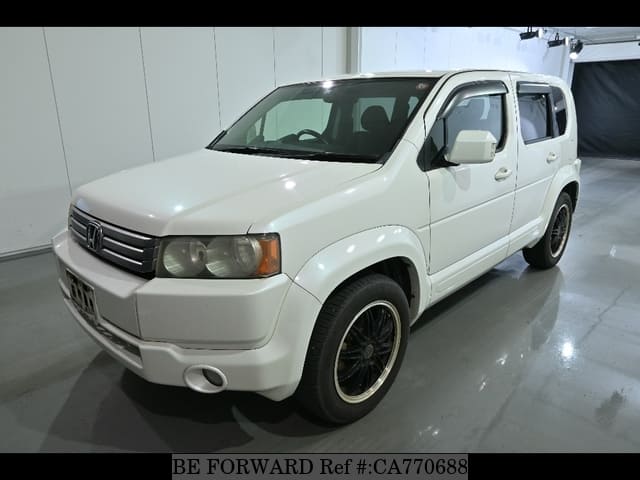 A grey JDM sports car speeding down a highway at night.