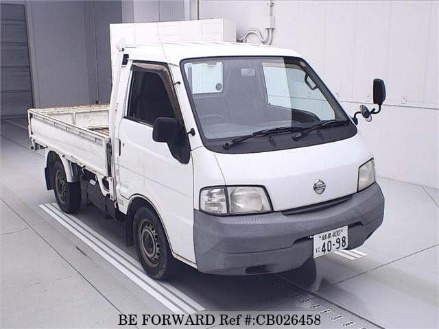 A grey JDM sports car speeding down a highway at night.