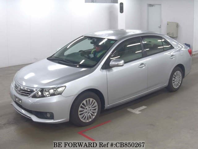 A grey JDM sports car speeding down a highway at night.