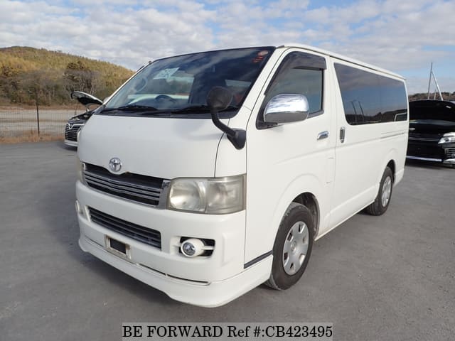 A grey JDM sports car speeding down a highway at night.