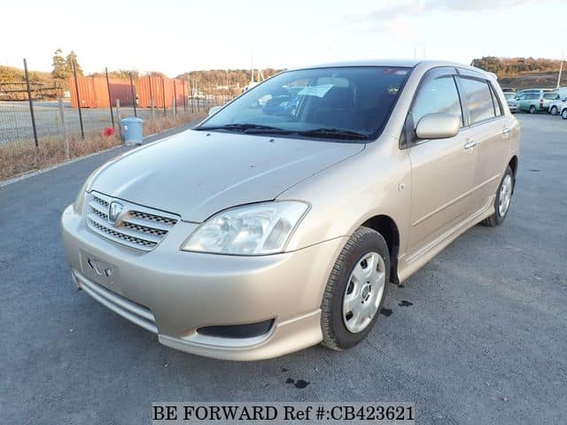 A grey JDM sports car speeding down a highway at night.