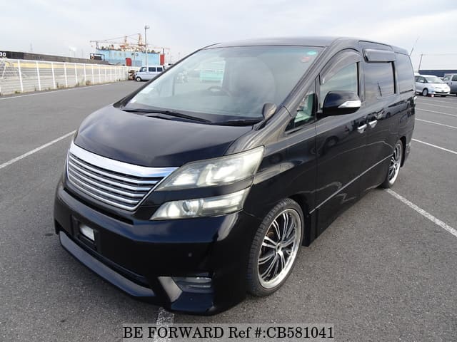 A grey JDM sports car speeding down a highway at night.