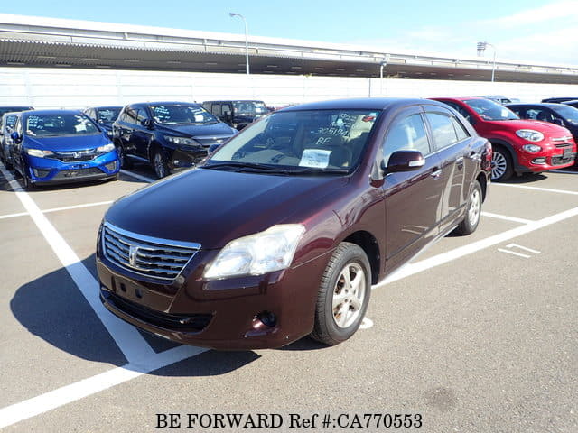 A grey JDM sports car speeding down a highway at night.