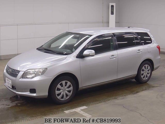 A grey JDM sports car speeding down a highway at night.