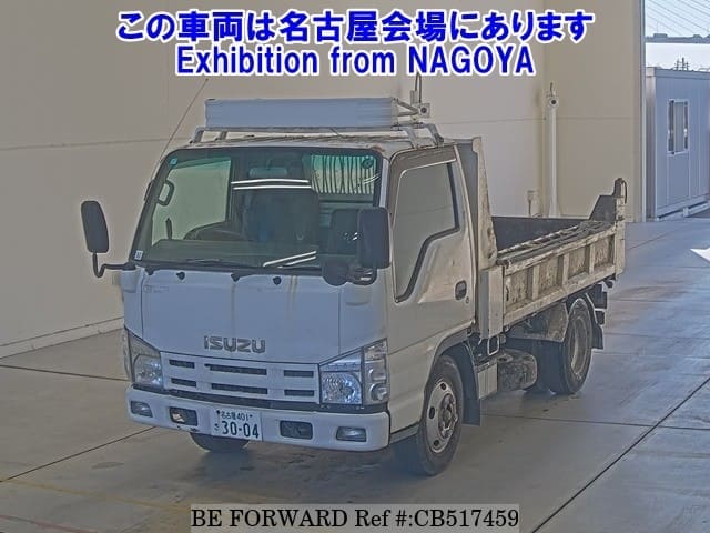 A grey JDM sports car speeding down a highway at night.