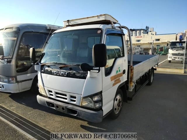 A grey JDM sports car speeding down a highway at night.