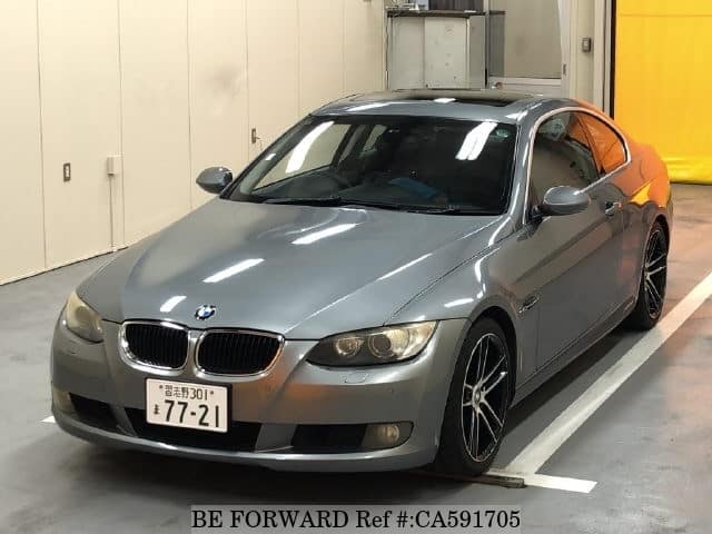 A grey JDM sports car speeding down a highway at night.