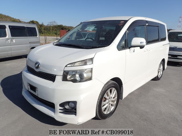 A grey JDM sports car speeding down a highway at night.