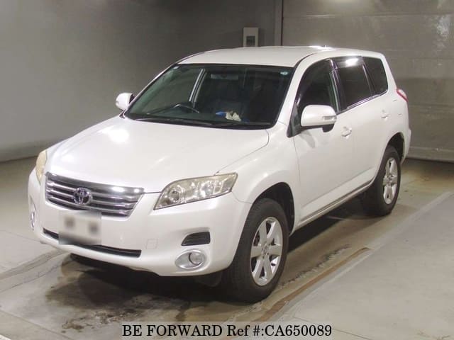 A grey JDM sports car speeding down a highway at night.