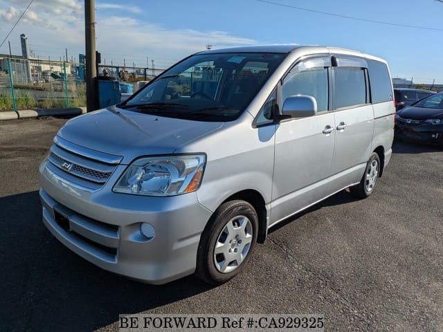 A grey JDM sports car speeding down a highway at night.