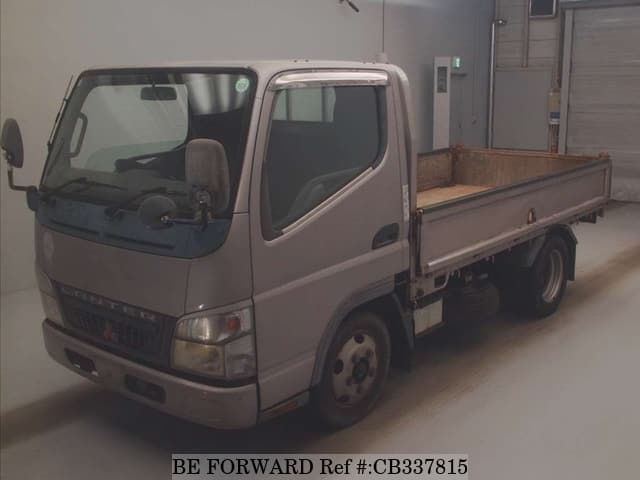 A grey JDM sports car speeding down a highway at night.
