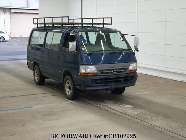 A grey JDM sports car speeding down a highway at night.