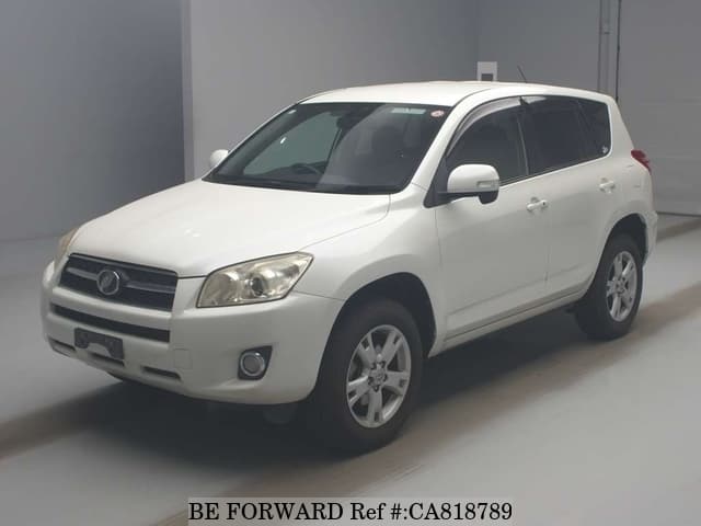 A grey JDM sports car speeding down a highway at night.