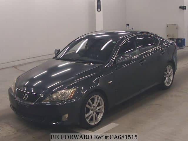 A grey JDM sports car speeding down a highway at night.