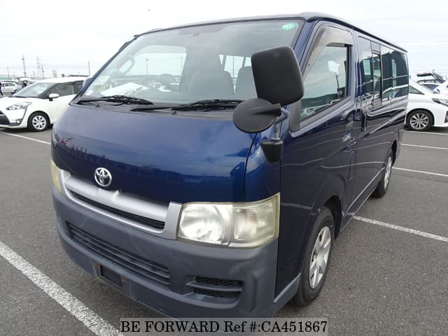 A grey JDM sports car speeding down a highway at night.