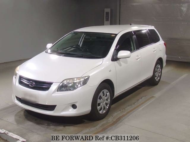 A grey JDM sports car speeding down a highway at night.