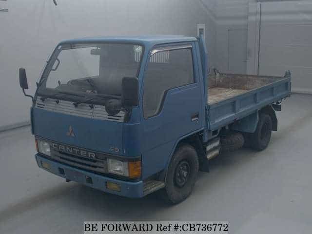 A grey JDM sports car speeding down a highway at night.