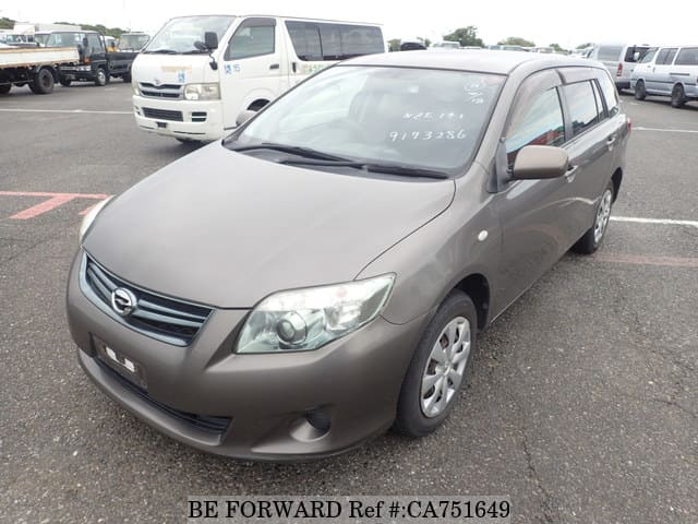 A grey JDM sports car speeding down a highway at night.