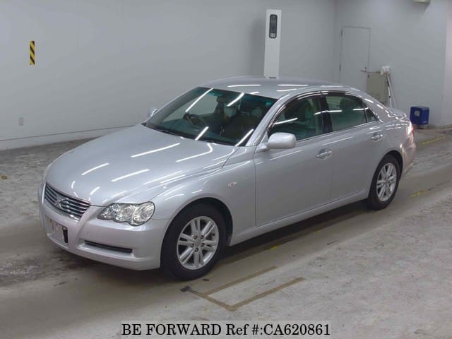 A grey JDM sports car speeding down a highway at night.