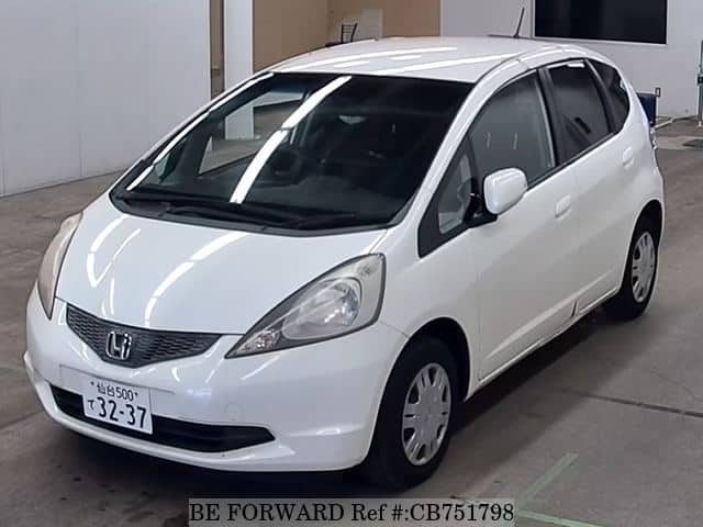 A grey JDM sports car speeding down a highway at night.