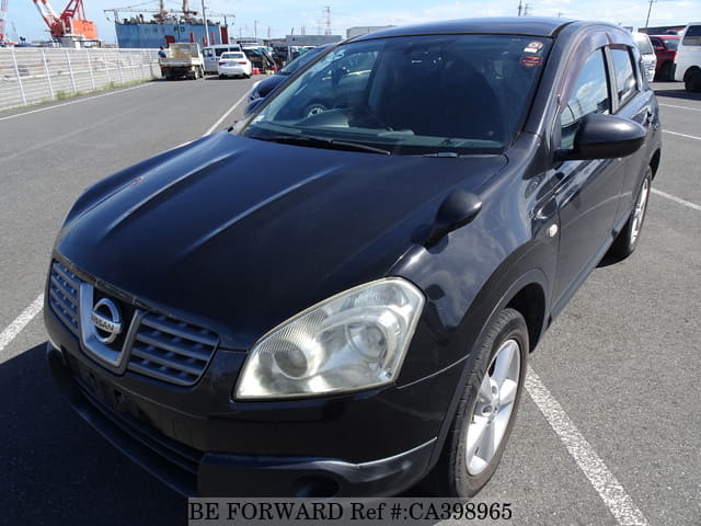 A grey JDM sports car speeding down a highway at night.