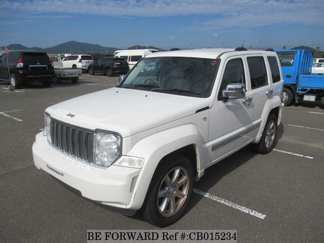A grey JDM sports car speeding down a highway at night.